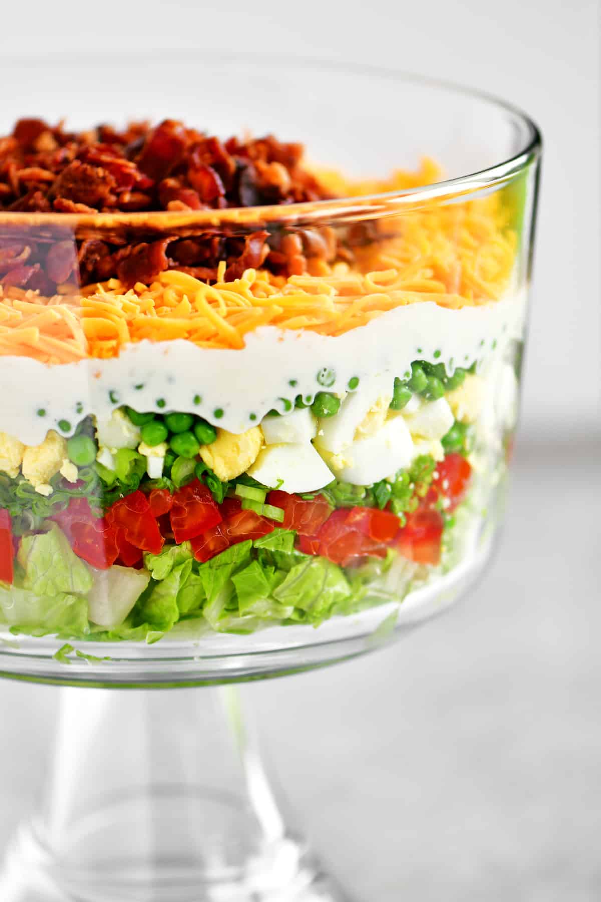 a layered salad in a trifle dish.