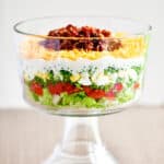 7 layer salad in a trifle dish.