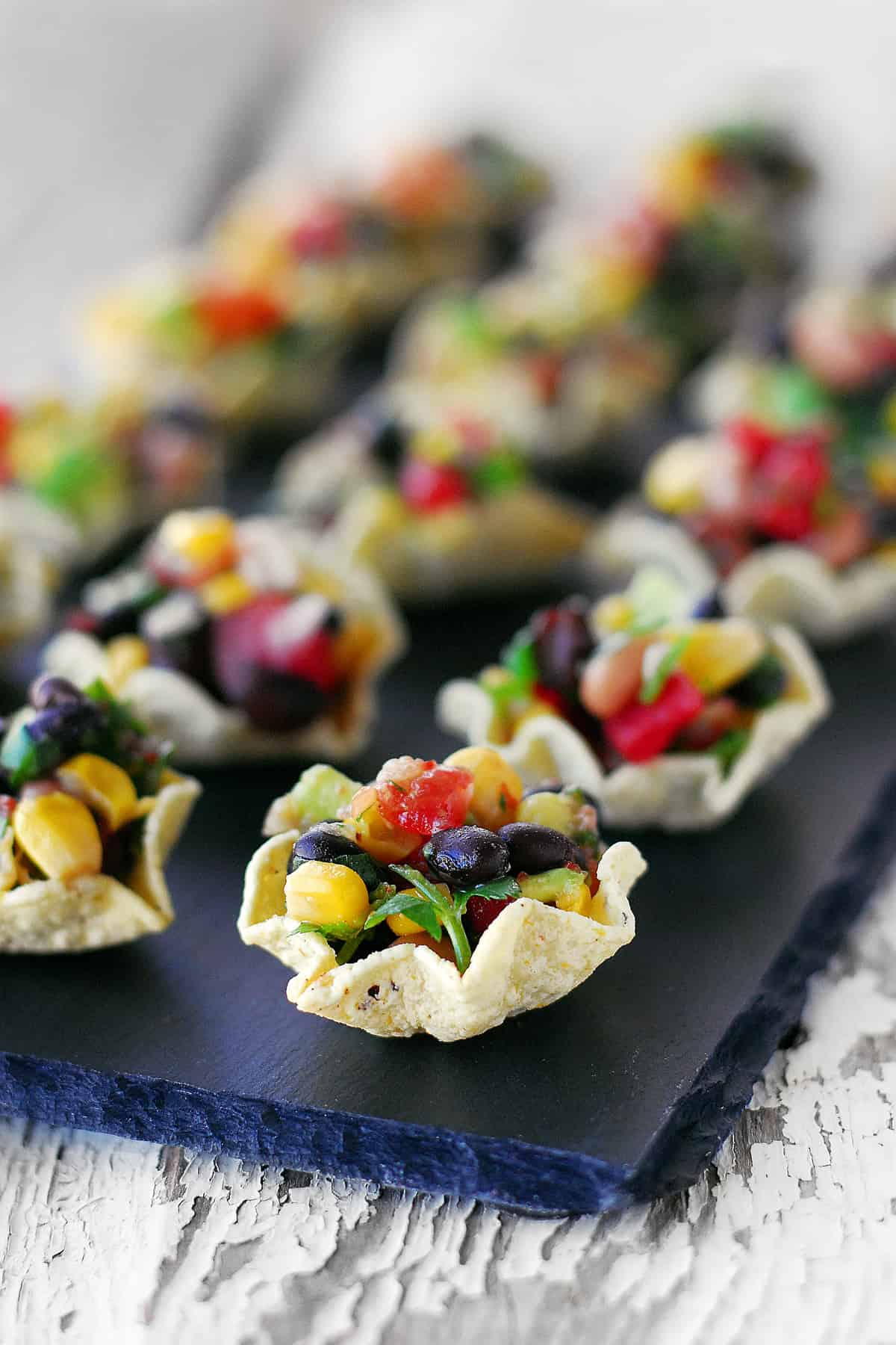 Corn chip cups with cowboy salsa inside.