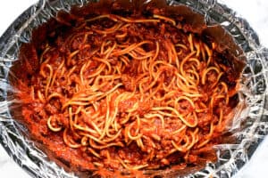 A crock pot full of Spaghetti.