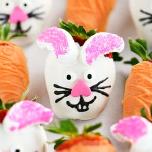 Easter chocolate covered strawberries decorated to look like the Easter bunny and carrots.