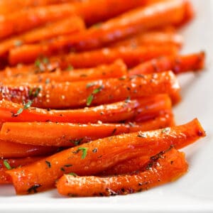 Seasoned, glazed carrots on a tray.
