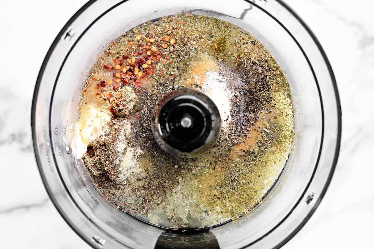 Spices and dressing ingredients in a food processor.