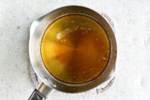 Cooling lemon glaze in a saucepan.