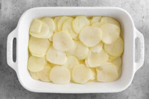 Line pan with potato slices.