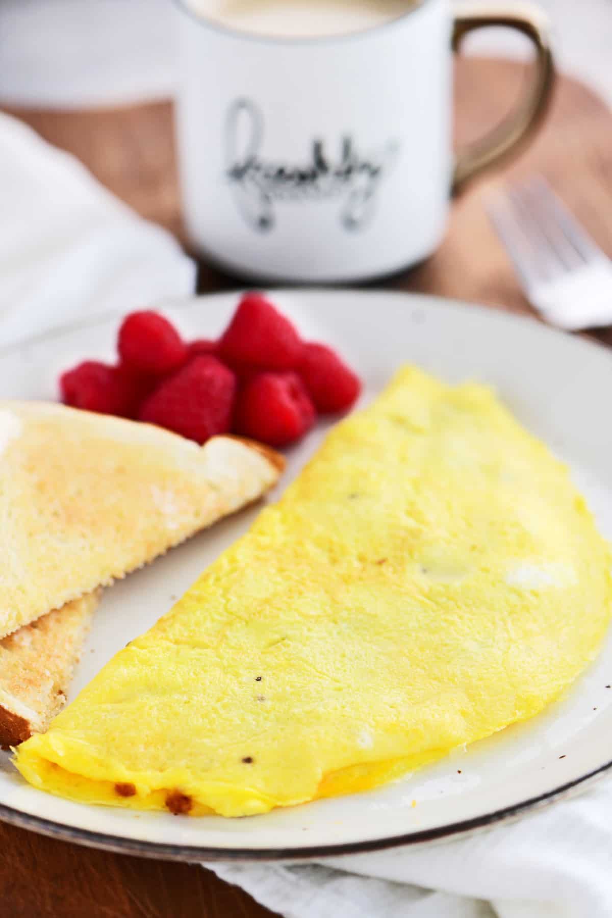 An Omelette with toast and berries.