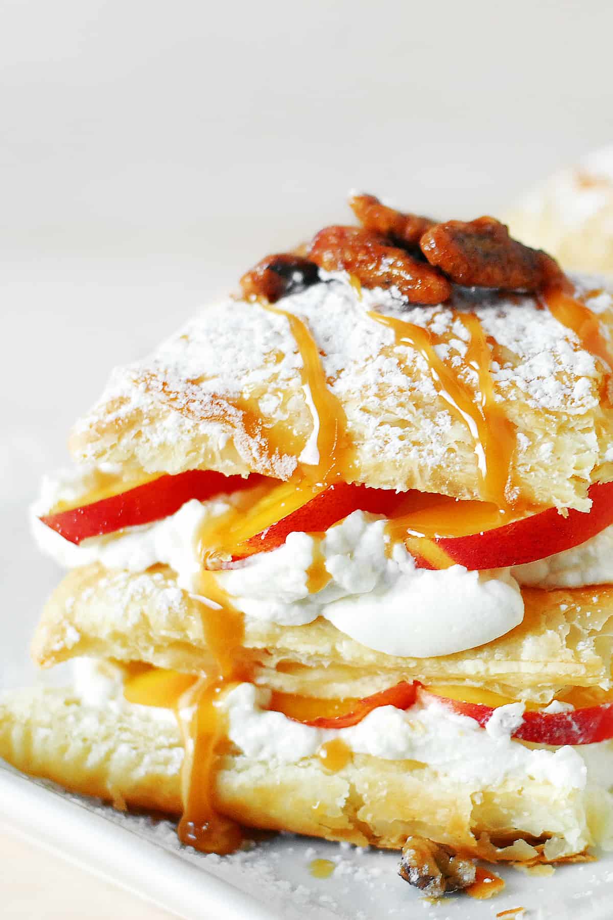 Napoleon pastry with cream and sliced peaches.