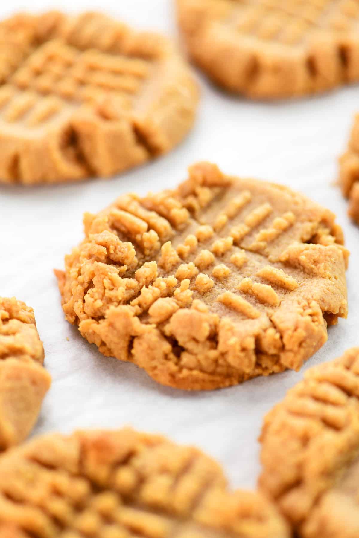 Baked 4 ingredient peanut butter cookies on parchment.