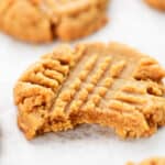 4 ingredient peanut butter cookies, one with a bite out of it.
