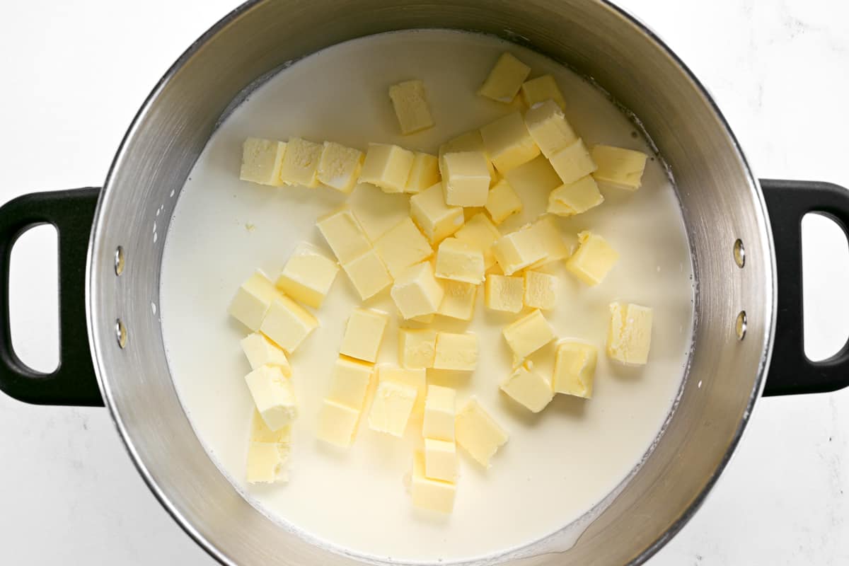 Butter cubes and heavy cream in a saucepan.