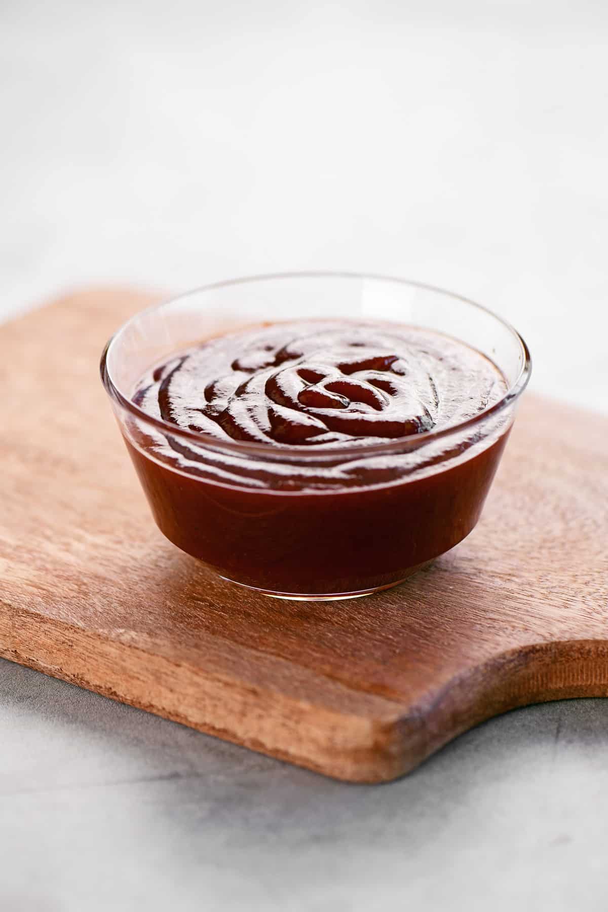 Barbeque sauce in a plastic dipping bowl.