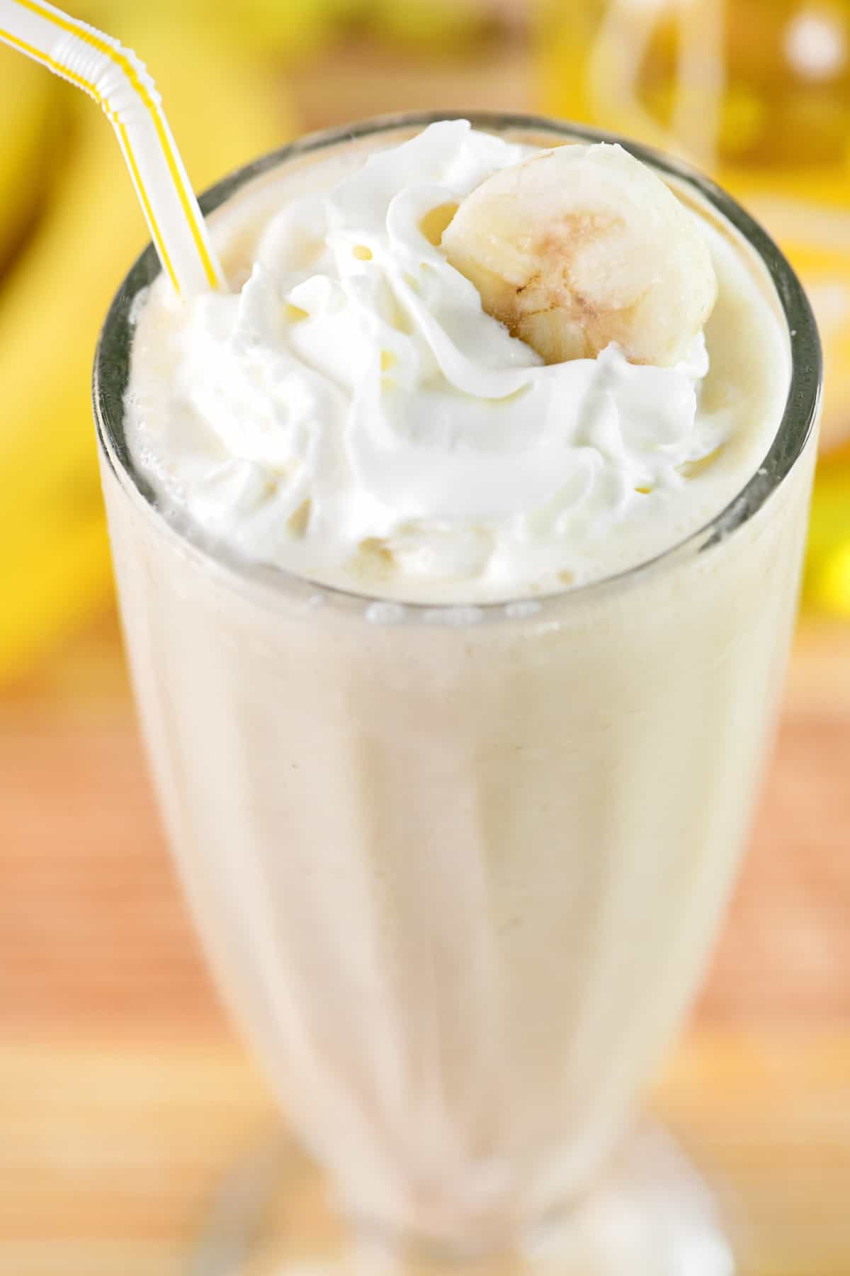 Banana milkshake with whipped cream on top.