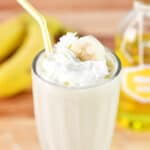 A banana milkshake with whipped cream on top.