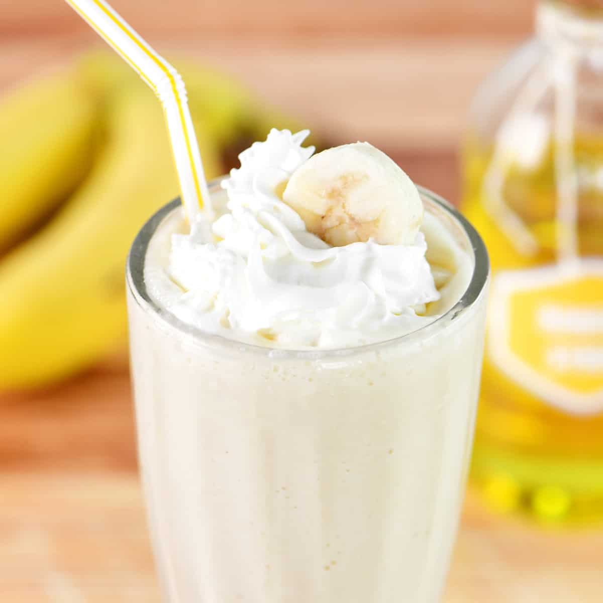 A banana milkshake with whipped cream on top.