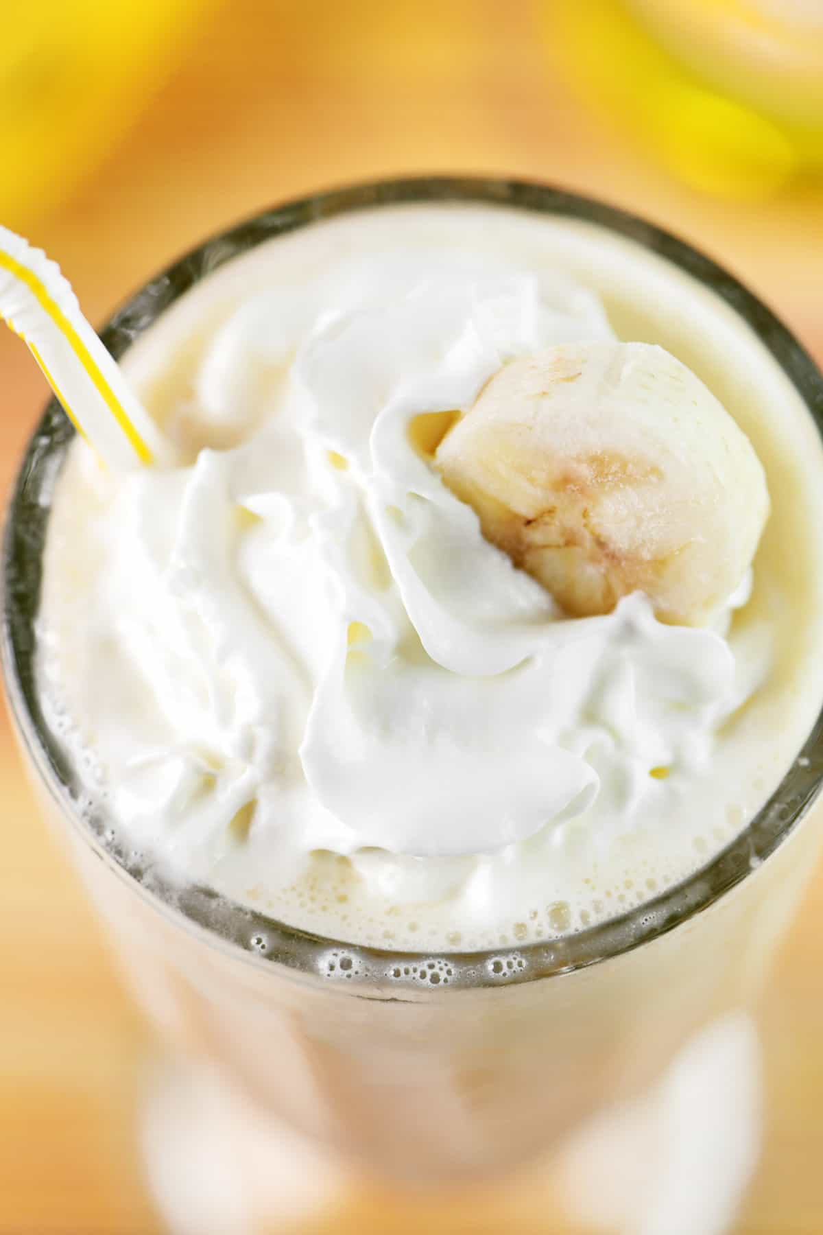 Top of a banana milkshake with whipped cream.