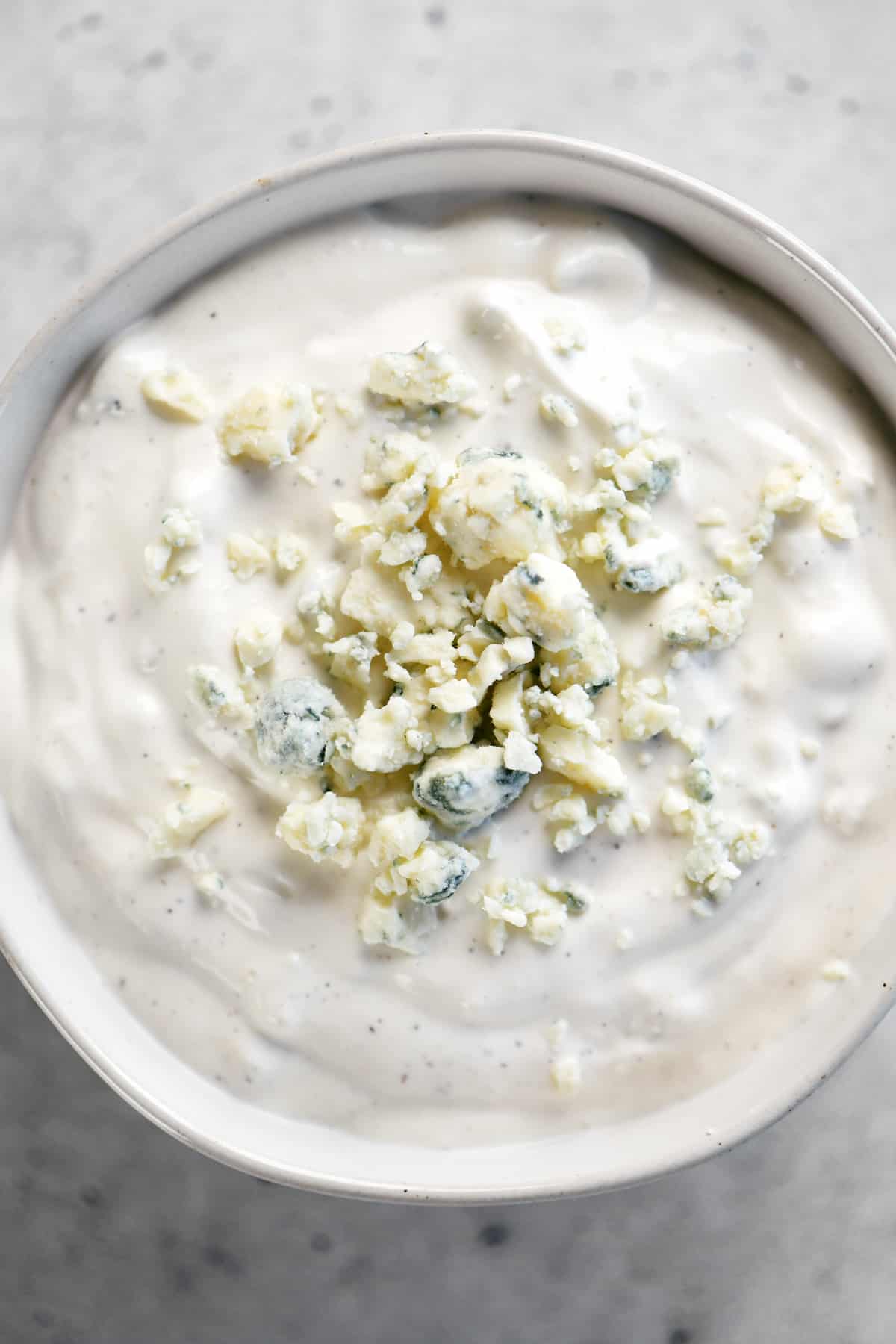 A bowl with Blue Cheese sauce inside.