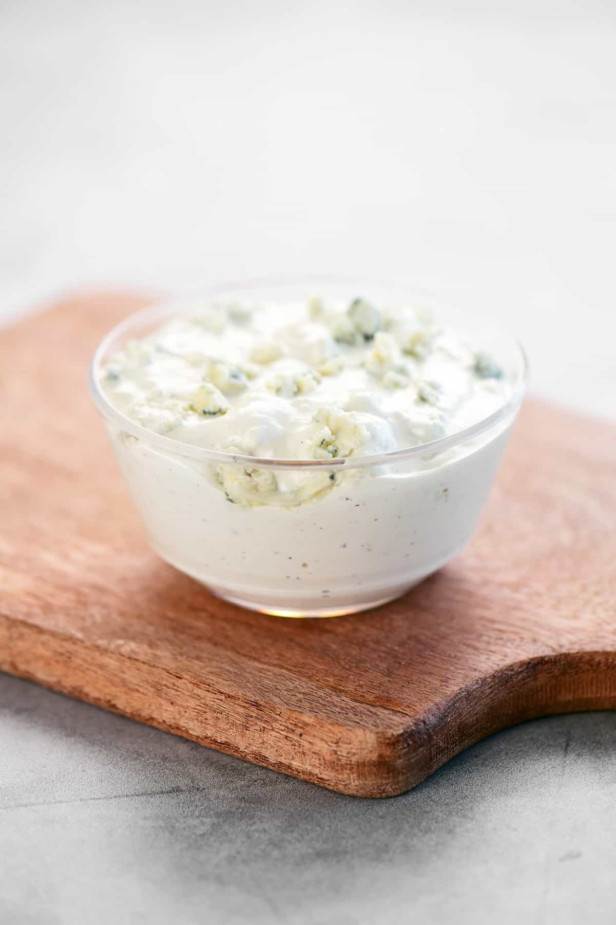 Blue Cheese sauce in a plastic dipping bowl.