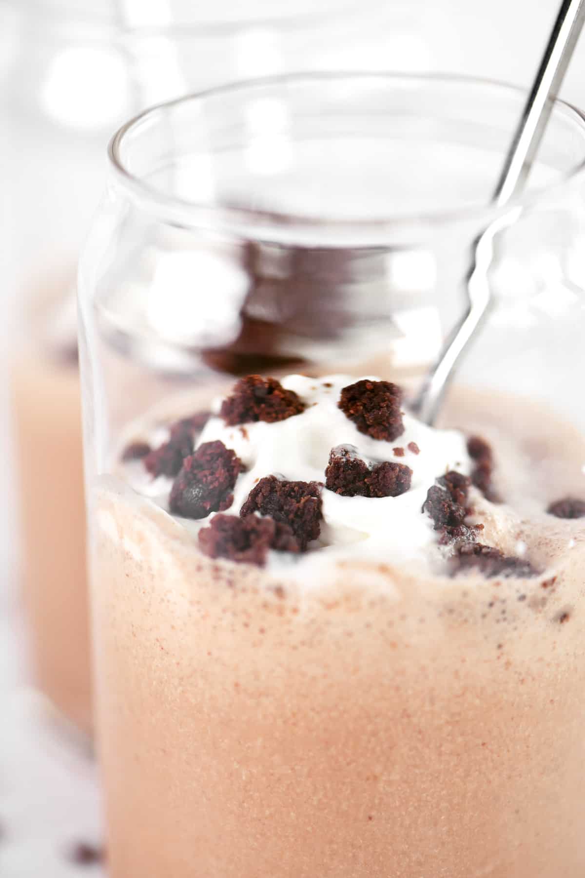 A brownie milkshake with whipped cream on top.