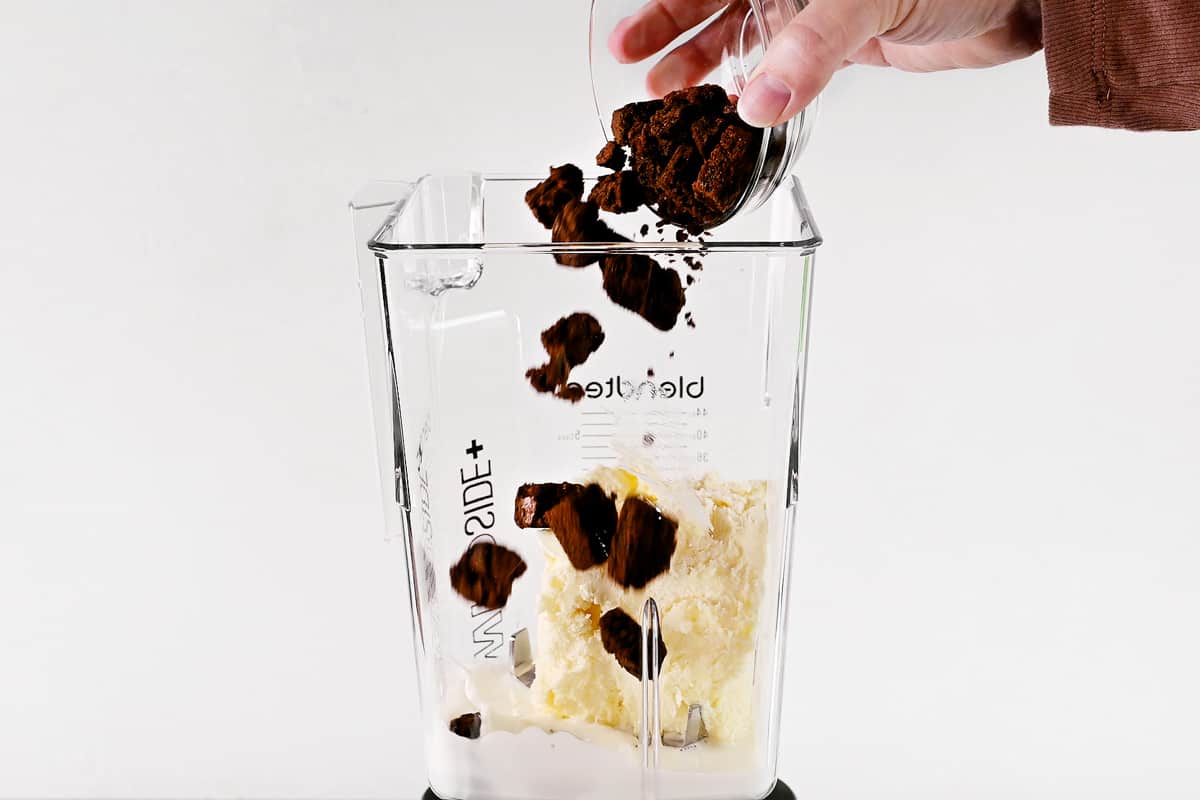Pouring ingredients into blender.