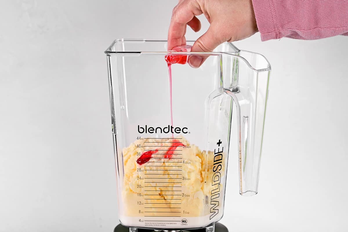 Adding flavoring to the blender.