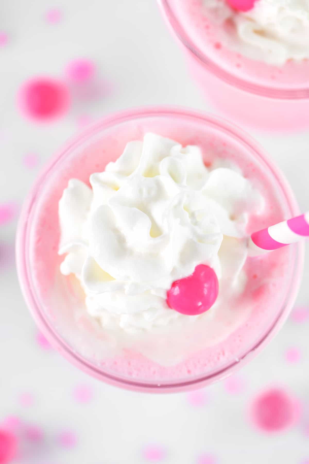 Bubblegum milkshake with whipped cream on top.