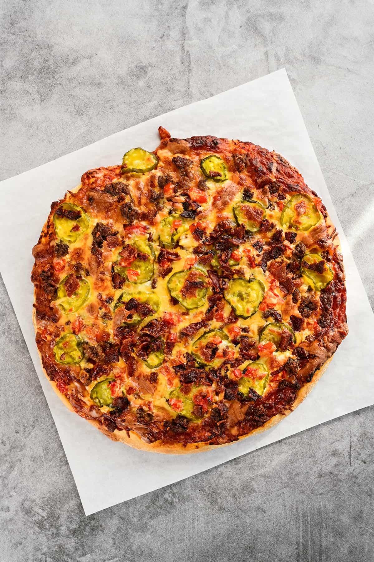 A cooked cheeseburger pizza.
