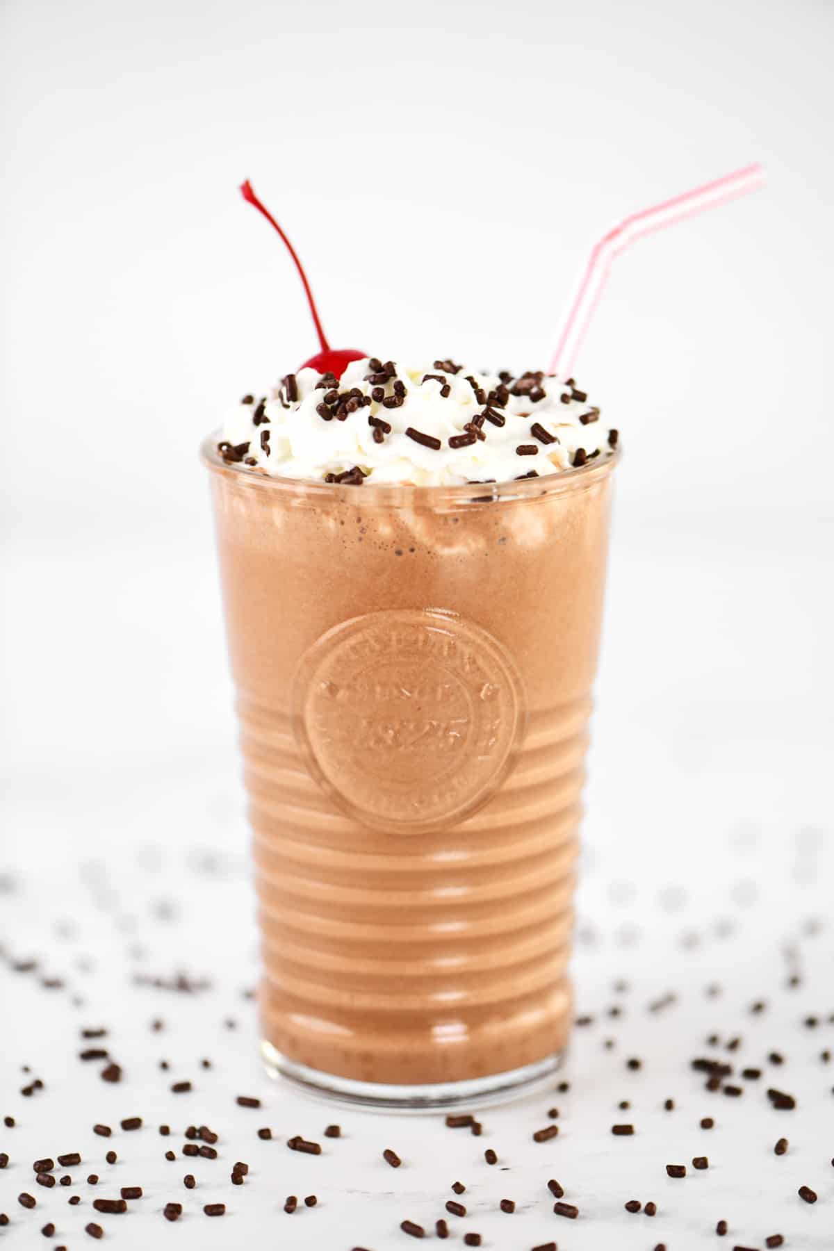 A chocolate milkshake on a countertop.
