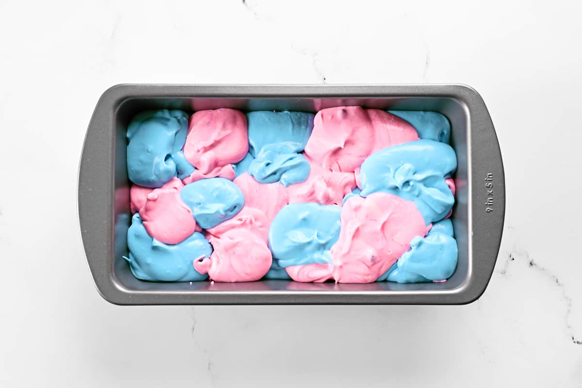 Pink and blue ice cream in a metal loaf pan.