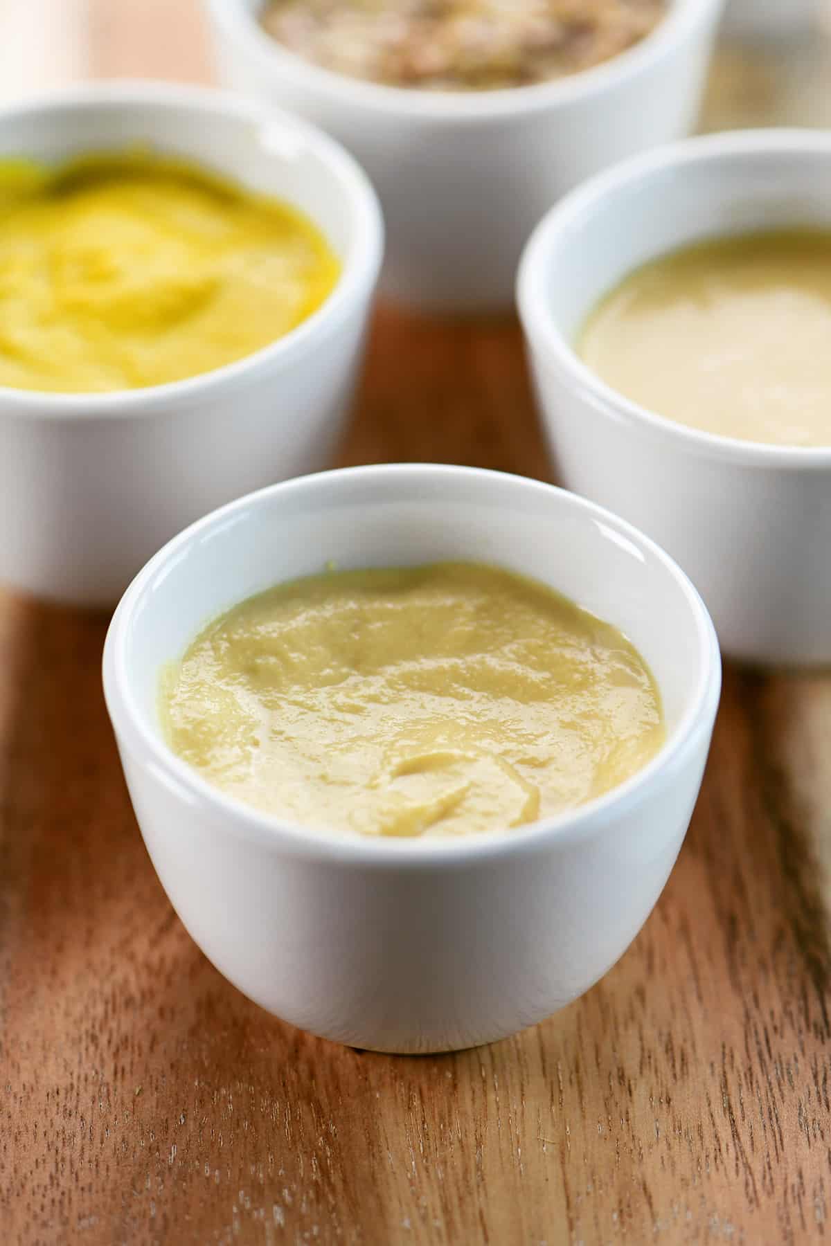 Dijon mustard in a small white condiment bowl.