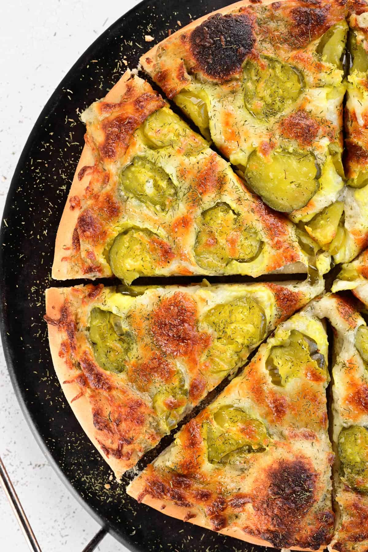 A sliced dill pickle pizza.