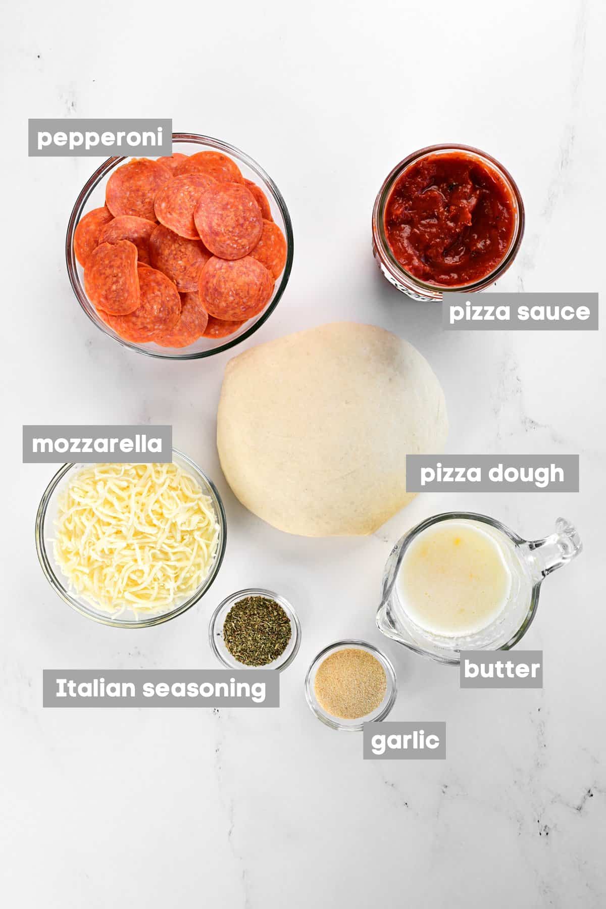 Ingredients on a white marble counter.