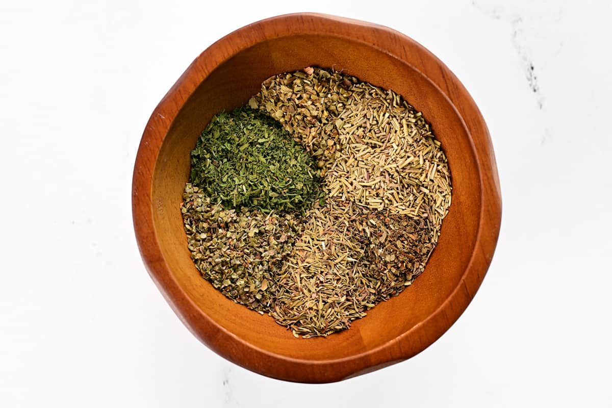 Spices inside of a wooden bowl.