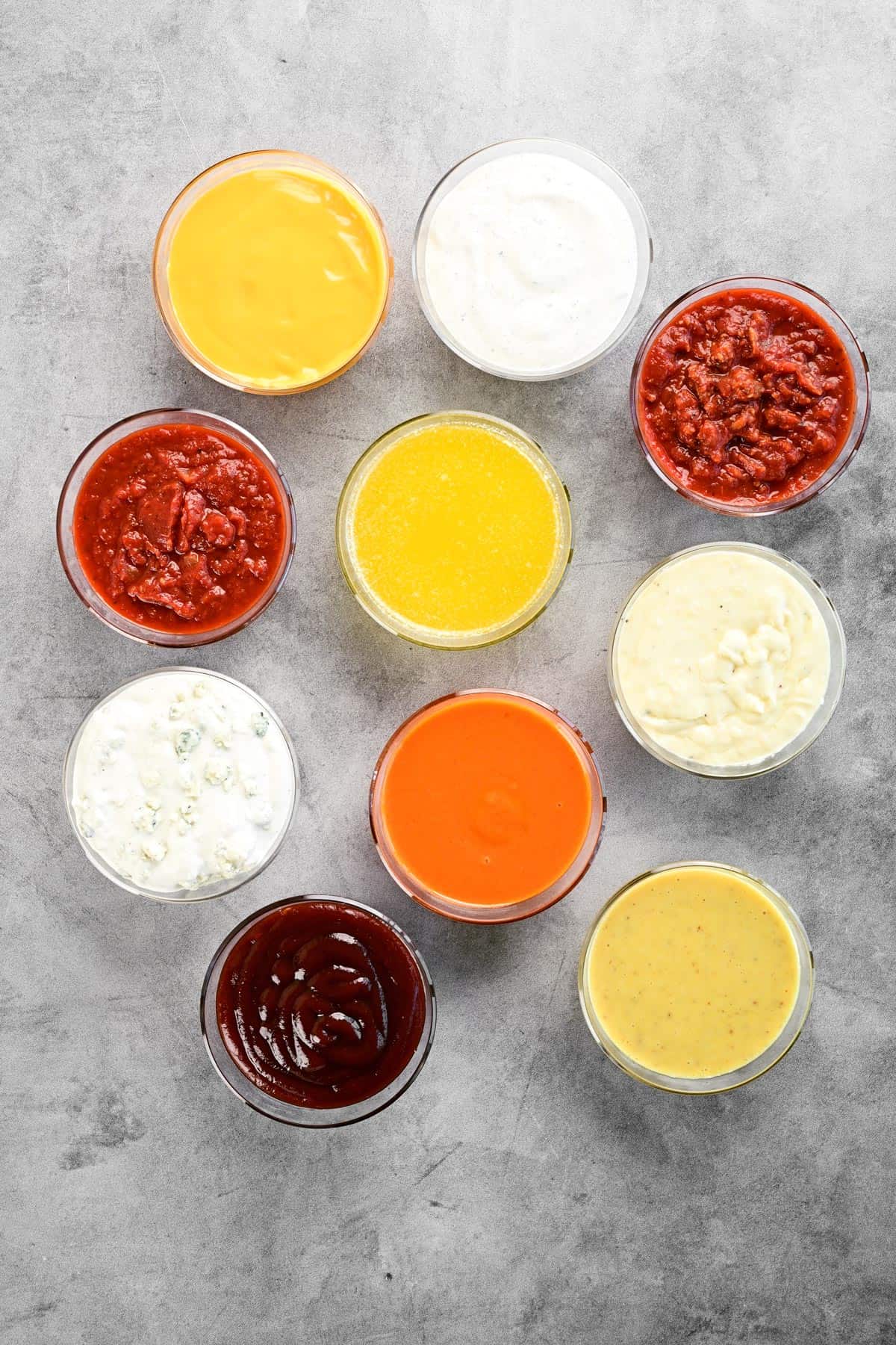 A countertop with several dipping sauces on it.