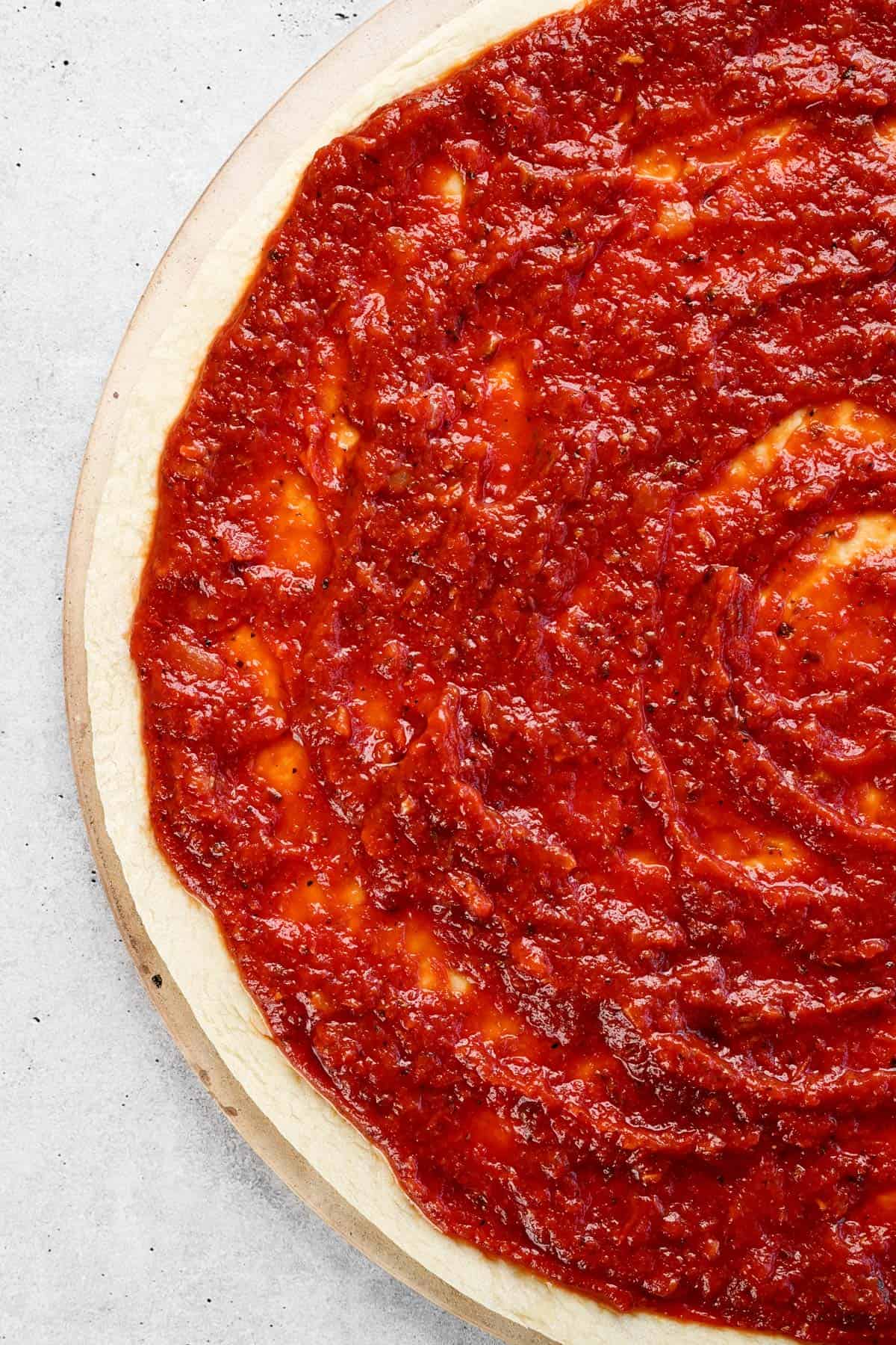 Sauce for pizza on a pizza dough.