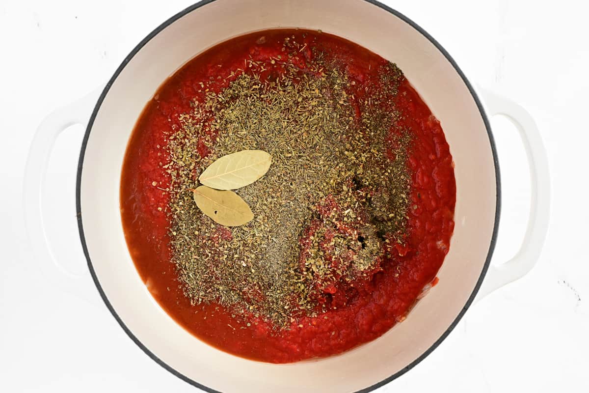 Red sauce and spices in a pot.