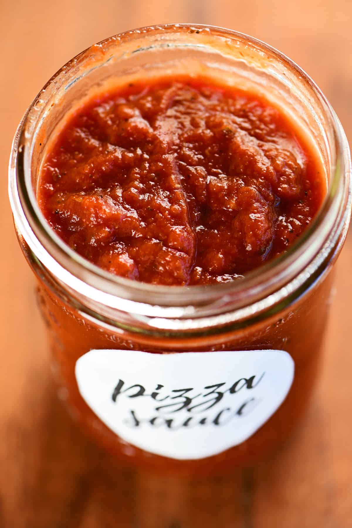 A jar with red sauce inside.