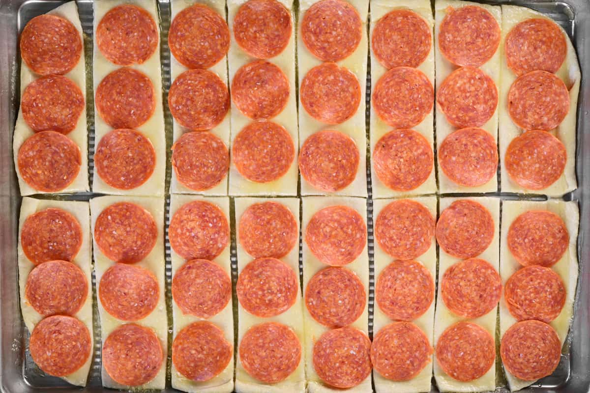 Top the dough with pepperoni slices.