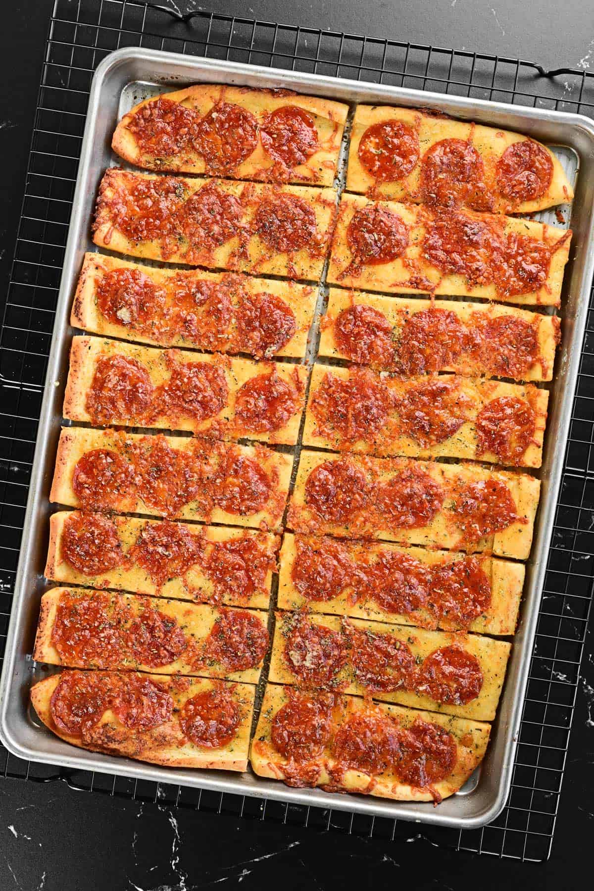 Baked pizza sticks in a pan.