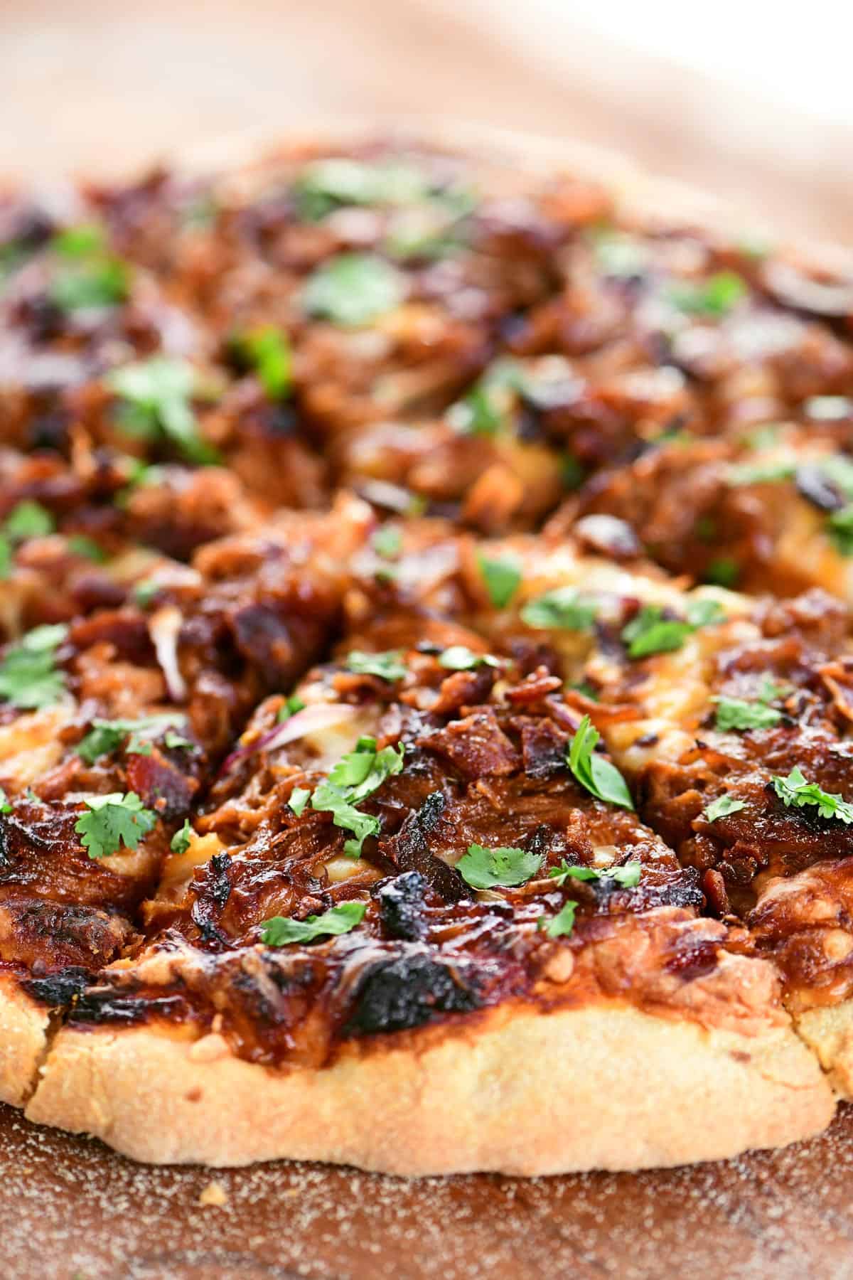 Pulled pork pizza cut into slices.