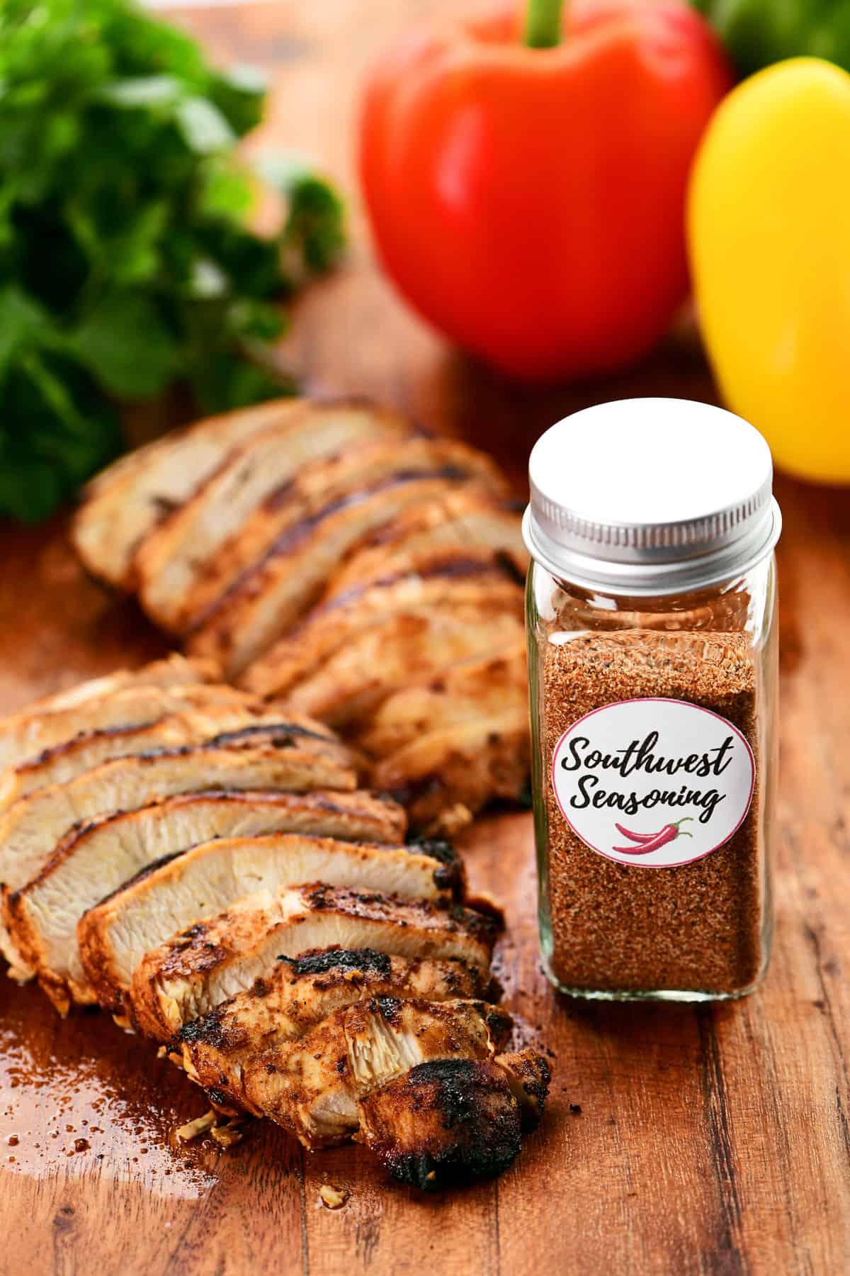 Southwest spice blend in a seasoning jar with chicken.