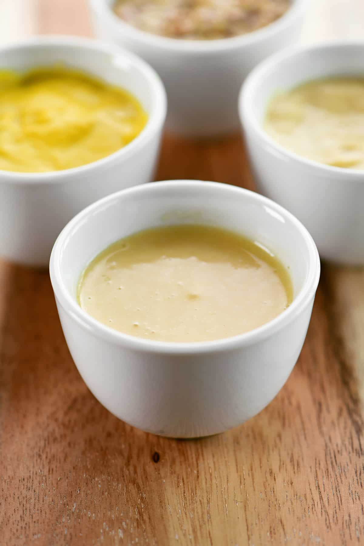 Spicy honey mustard in a small white condiment bowl.