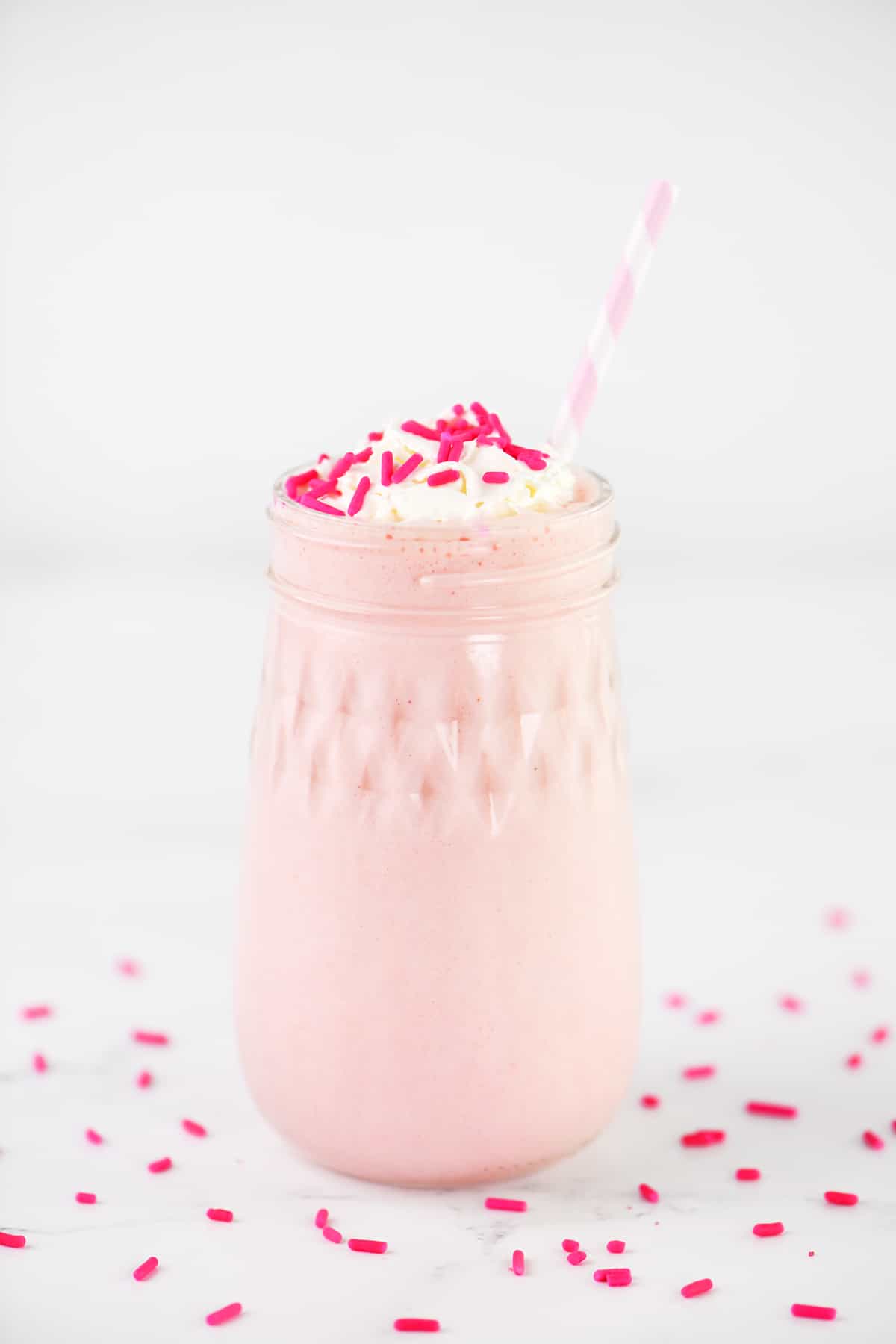 A strawberry shake in a glass jar.