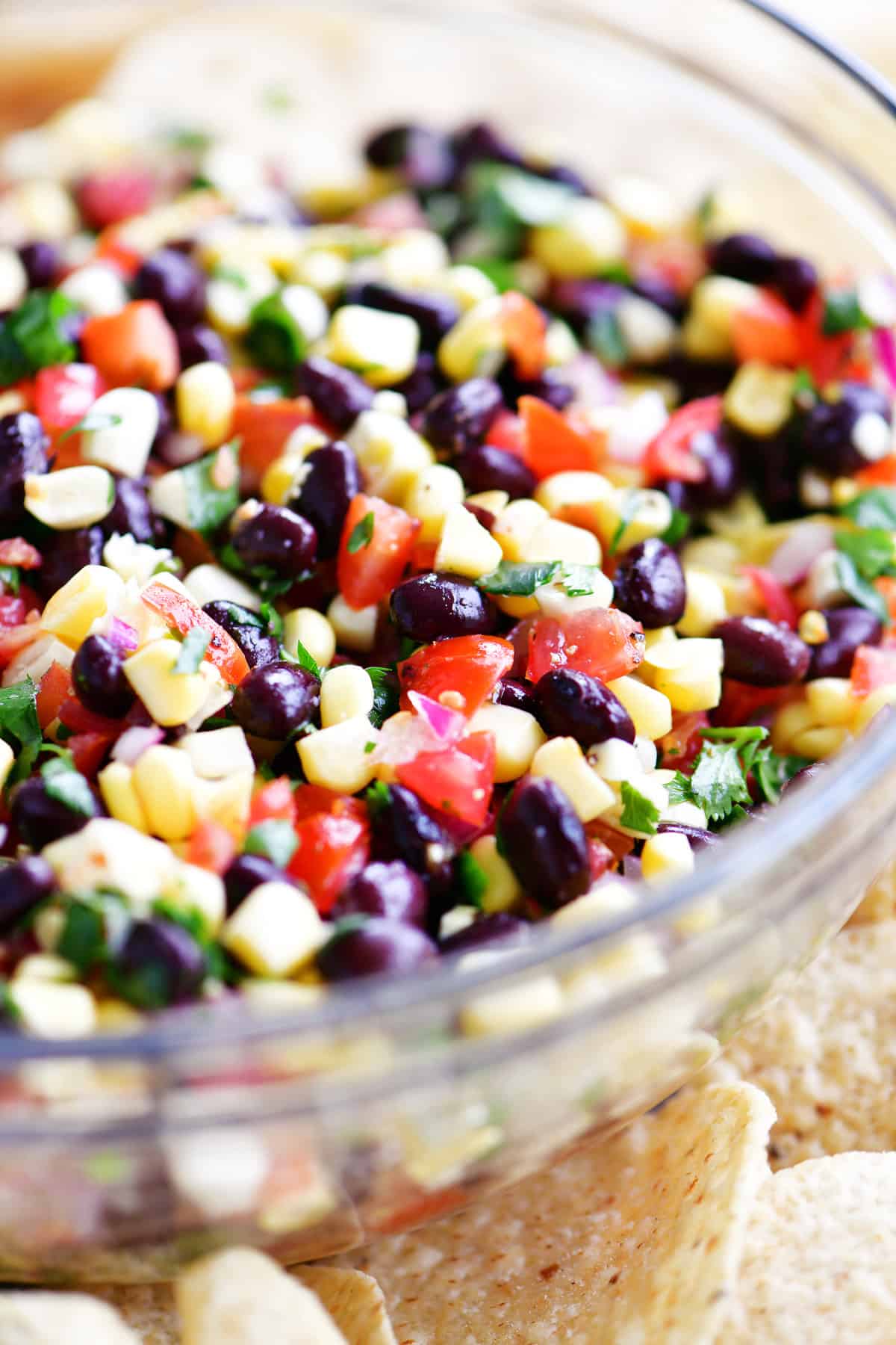 Black bean and corn salsa in a bowl surrounded by chips.