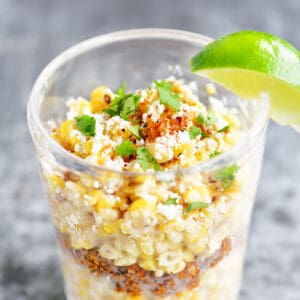 Corn in a cup with a lime wedge.