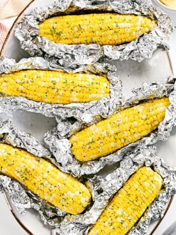 Grilled corn on the cob in foil.