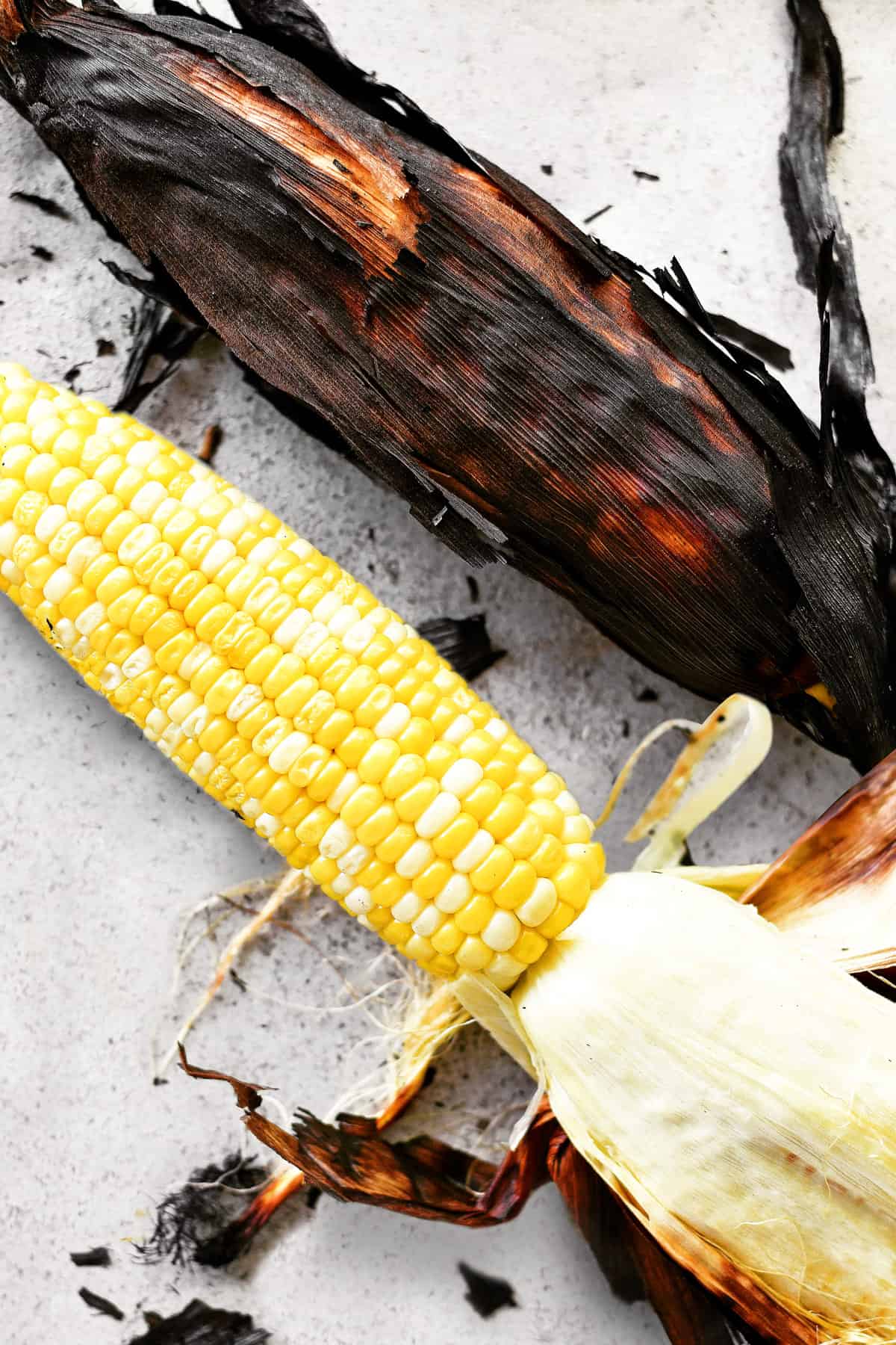 Grilled corn in the husks.