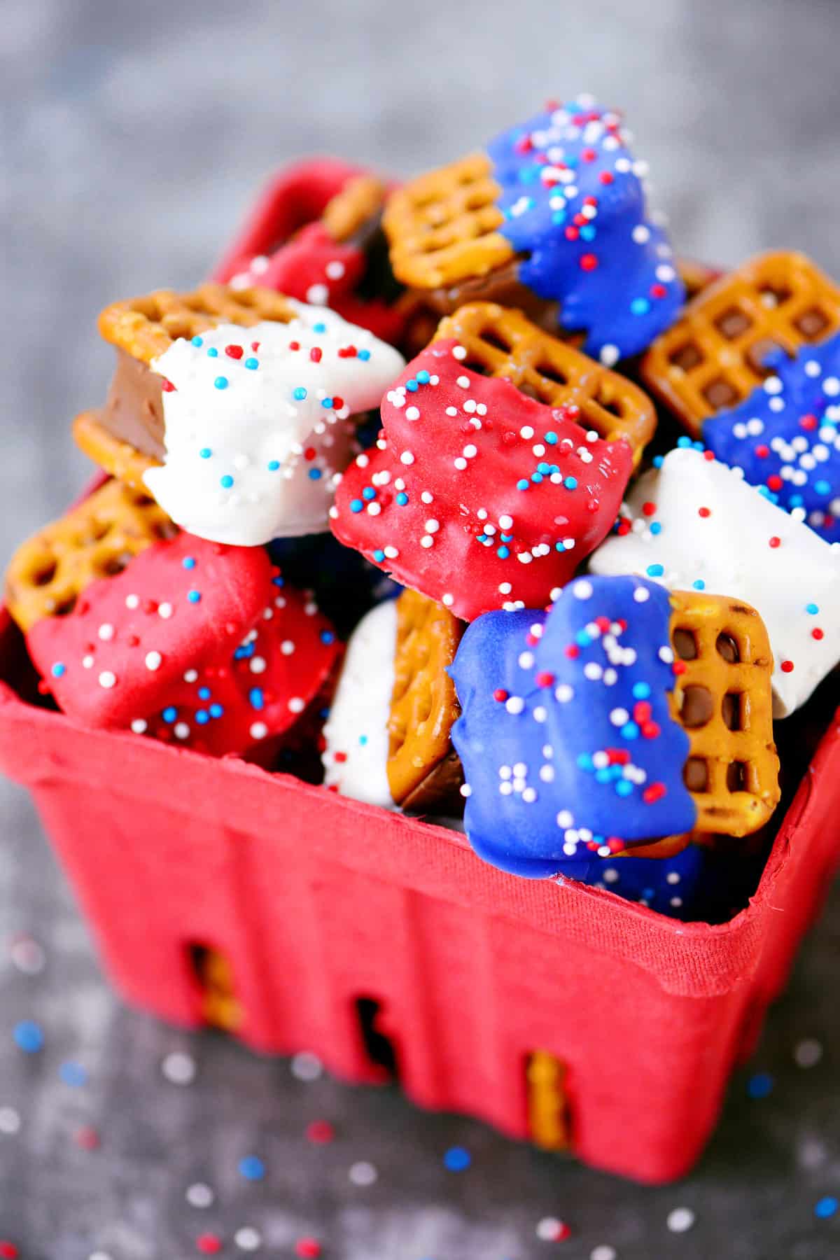 A red basket holding red, white, and blue treats.