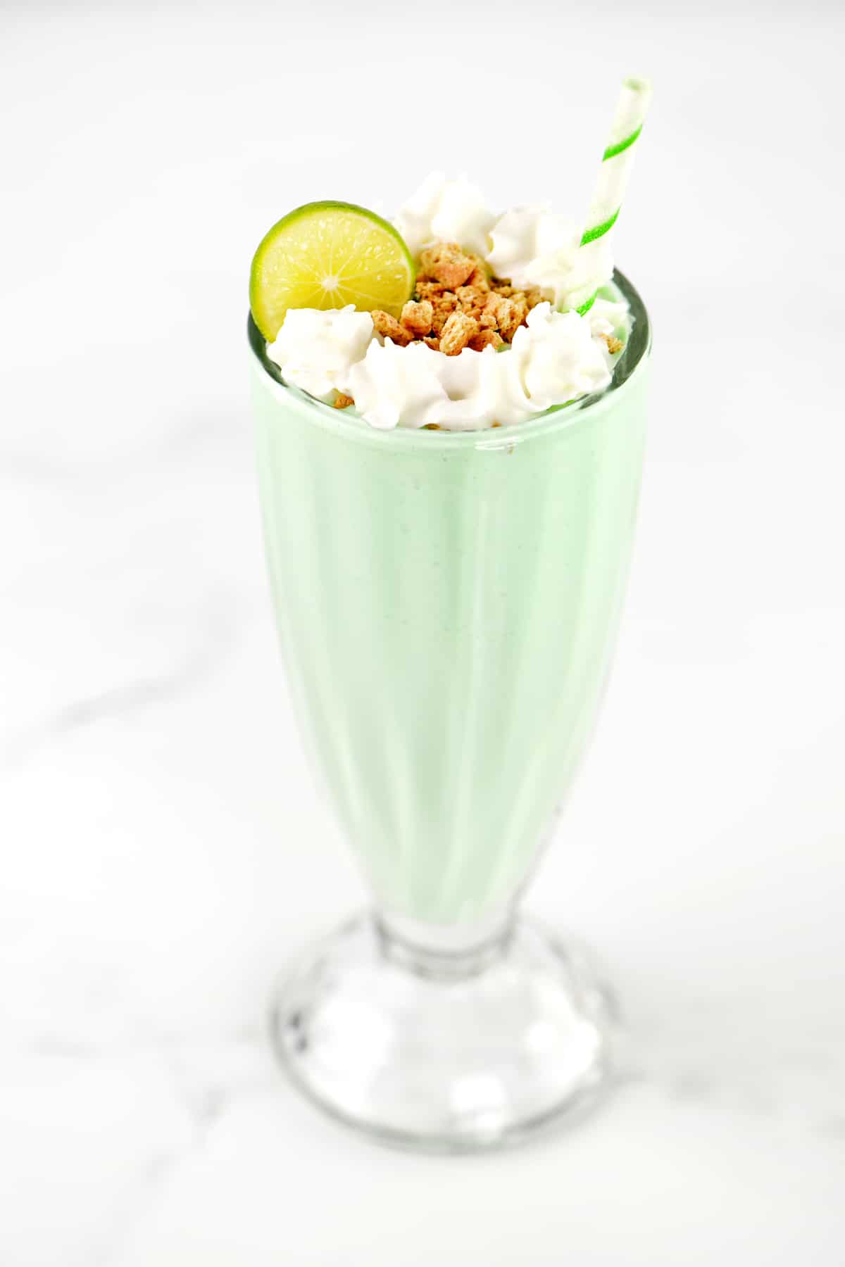 A lime milkshake in a glass.