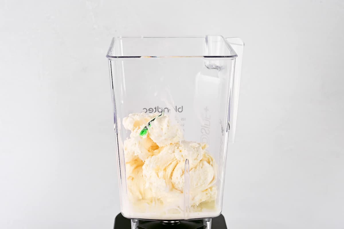 Ice cream and milk in a blender.