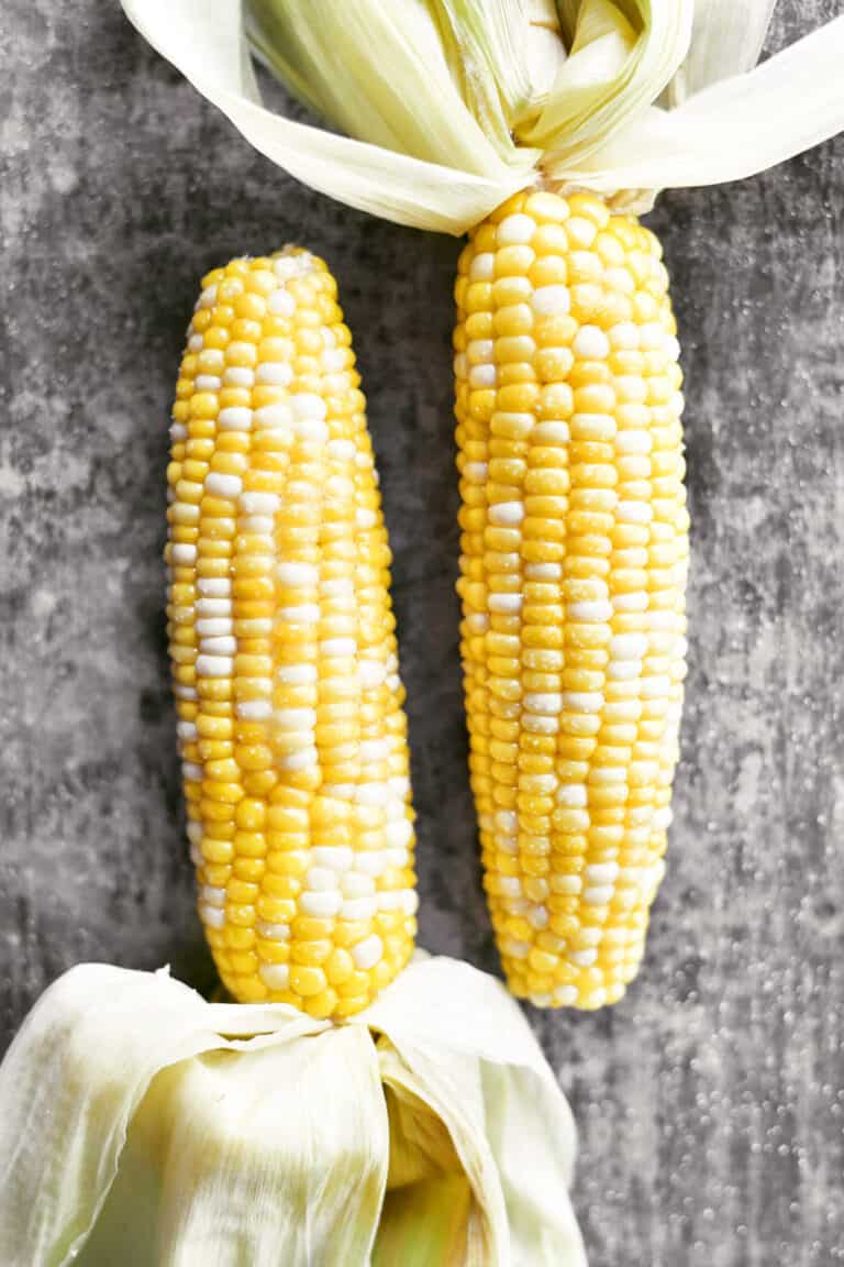 Two shucked cobs of corn.